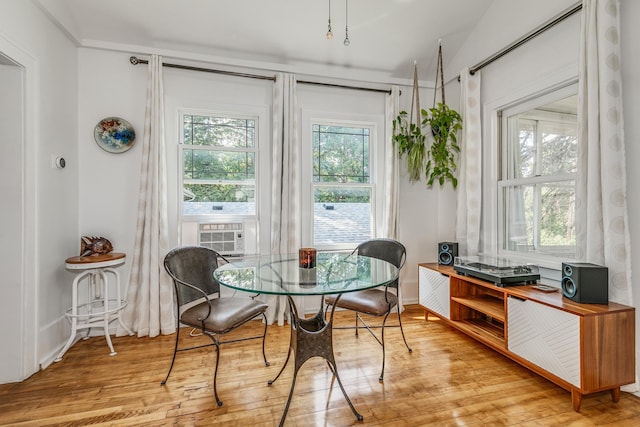 dining space featuring cooling unit and light hardwood / wood-style flooring