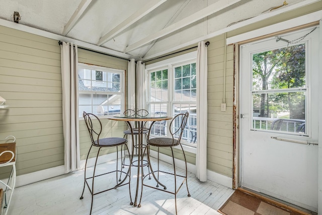 sunroom / solarium featuring lofted ceiling and a wealth of natural light