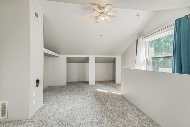 bonus room with light carpet, lofted ceiling, and ceiling fan