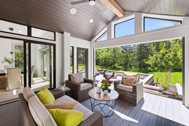 sunroom / solarium with wood ceiling, a healthy amount of sunlight, ceiling fan, and vaulted ceiling with beams