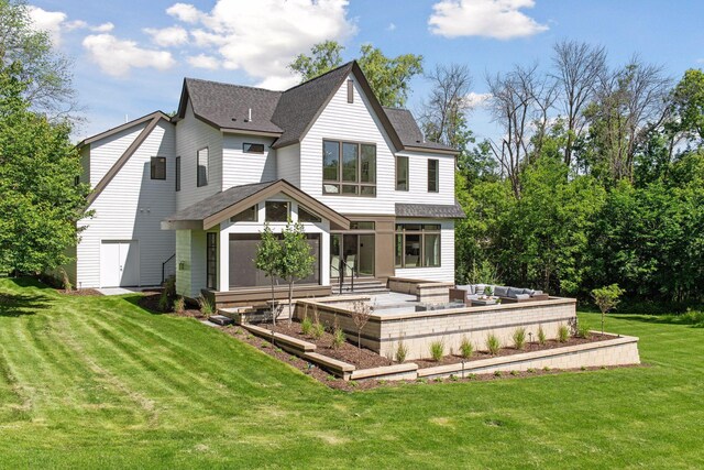 rear view of house with a garage and a lawn