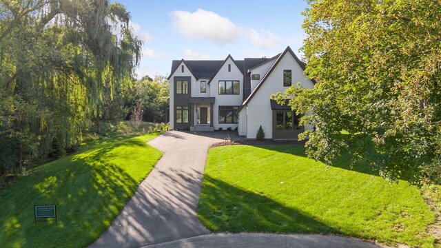 tudor house with a front lawn