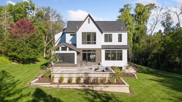 back of house with a lawn and a patio