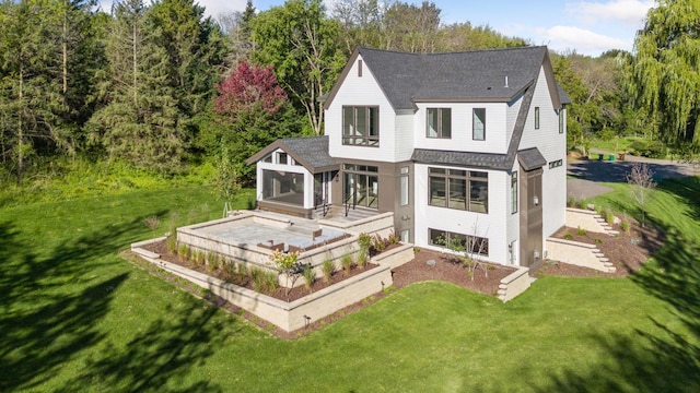 view of front of property with a sunroom and a front lawn