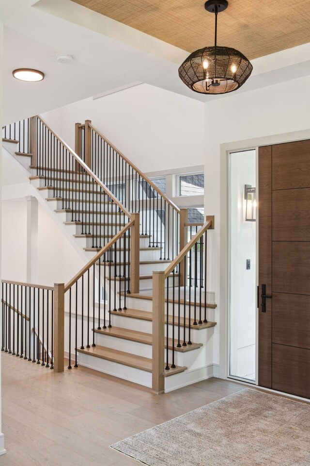 foyer featuring light hardwood / wood-style flooring and a chandelier