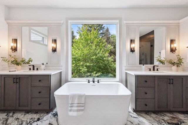 bathroom with vanity, plenty of natural light, and separate shower and tub