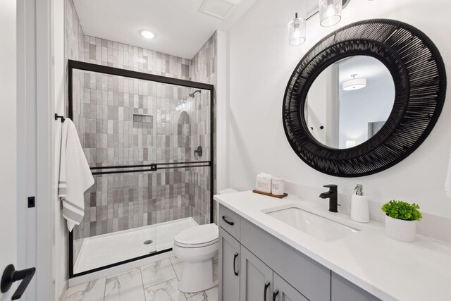 bathroom featuring vanity, toilet, and walk in shower