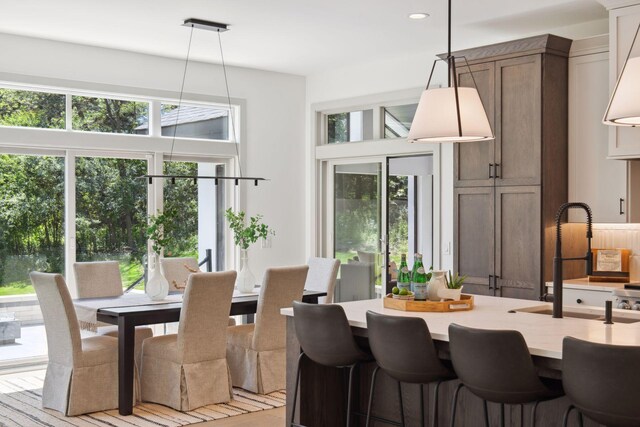 dining space with light hardwood / wood-style flooring and sink