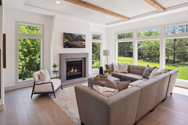 living room with plenty of natural light, hardwood / wood-style flooring, and beam ceiling