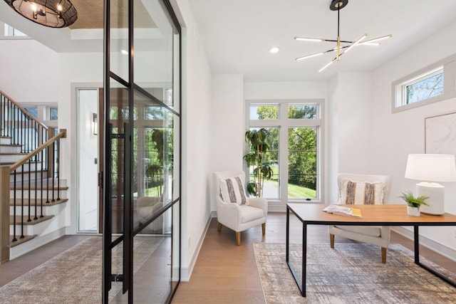 office area with hardwood / wood-style flooring and a notable chandelier