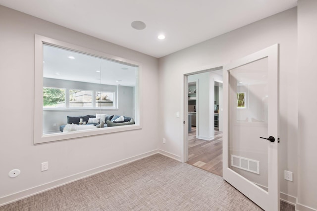 unfurnished room with light wood-type flooring