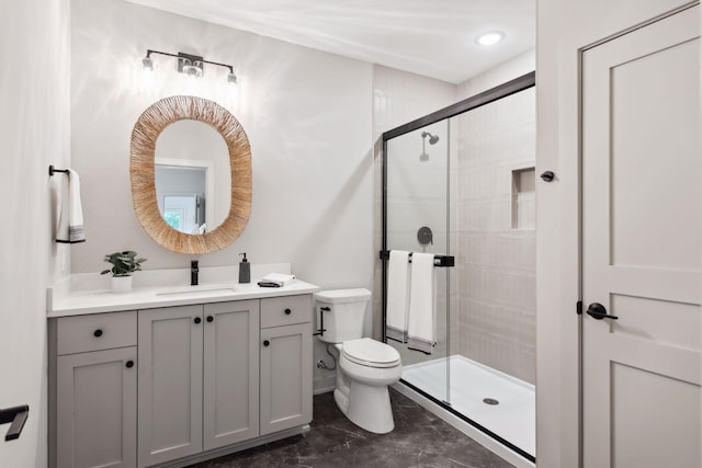 bathroom with vanity, toilet, and a shower with shower door