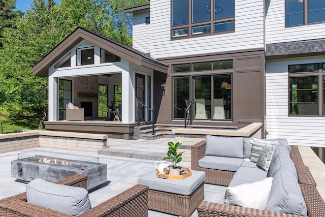 view of patio featuring an outdoor living space with a fire pit