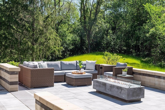 view of patio featuring an outdoor living space with a fire pit