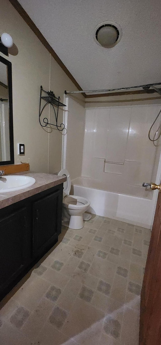 bathroom with shower / bath combination, toilet, vaulted ceiling, a textured ceiling, and vanity