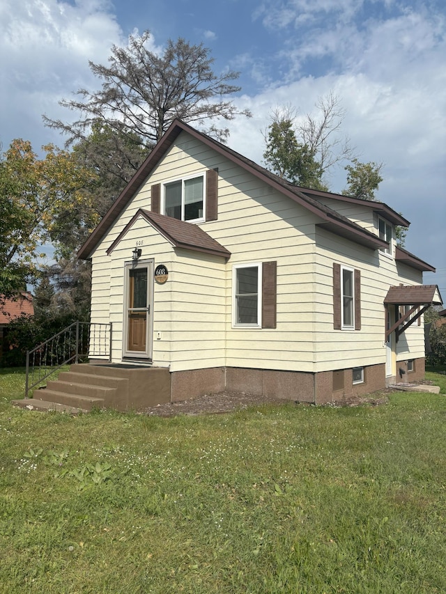 bungalow-style home with a front yard