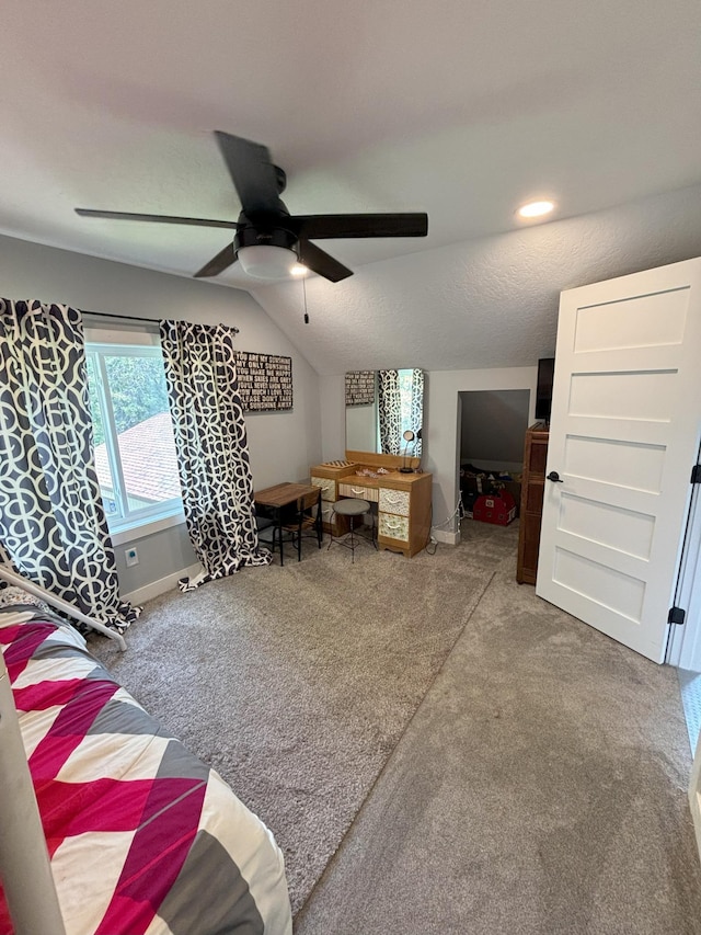 living room with ceiling fan, carpet floors, lofted ceiling, and a textured ceiling