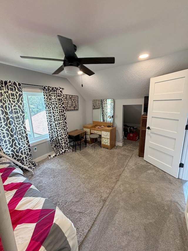 carpeted bedroom with ceiling fan and lofted ceiling