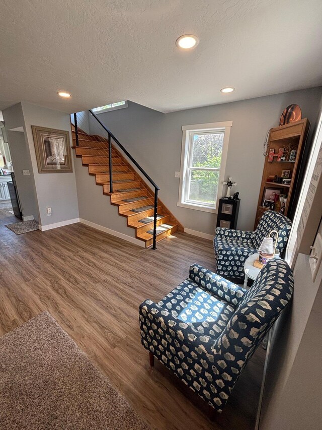 608 Granger Rd, Detroit Lakes, MN 56501 - sitting room featuring stairs, wood finished floors, baseboards, recessed lighting, and a textured ceiling