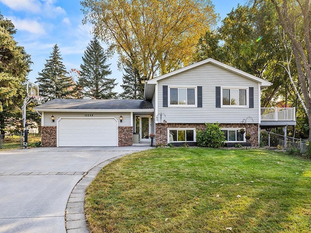 split level home with a garage and a front lawn