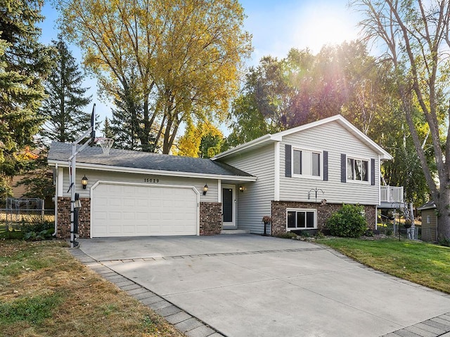 view of front of home featuring a garage and a front lawn