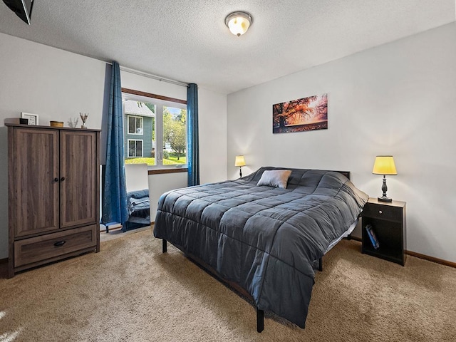 bedroom with light carpet and a textured ceiling