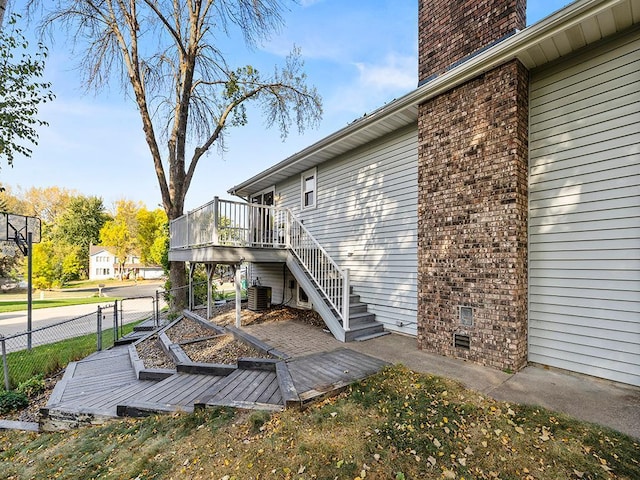 exterior space with a deck and central AC unit