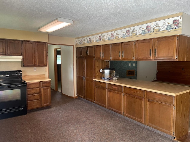 kitchen featuring black electric range and a textured ceiling