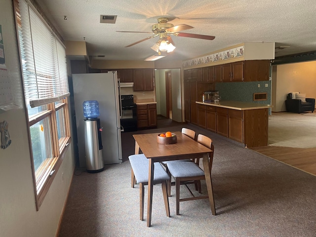 dining room with ceiling fan and a textured ceiling