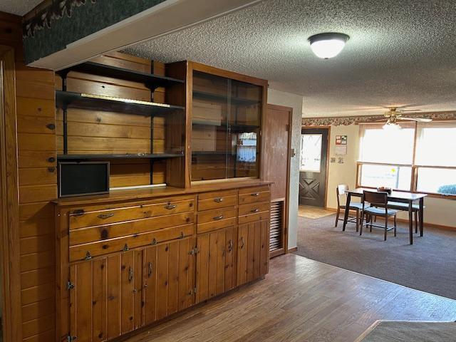 kitchen with light hardwood / wood-style floors and a textured ceiling