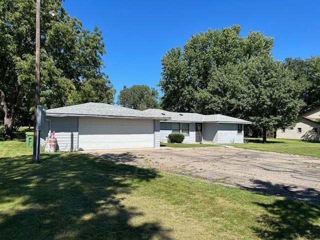 single story home with a garage and a front yard