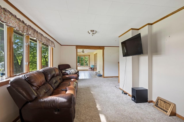 living area featuring carpet, crown molding, and baseboards