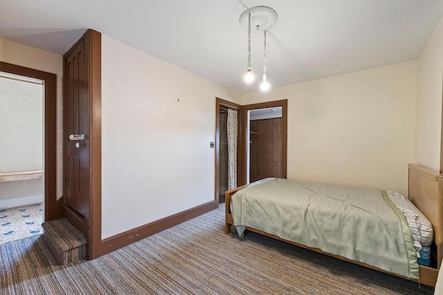 carpeted bedroom featuring baseboards