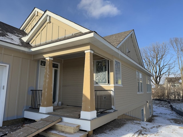 snow covered property featuring a porch