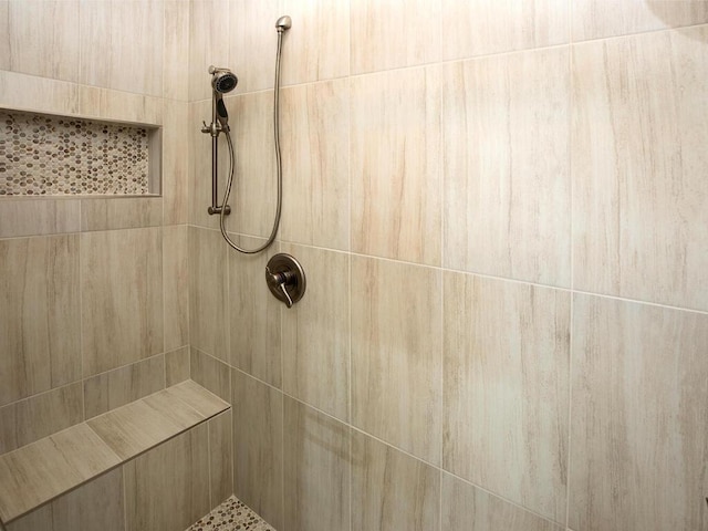 bathroom with a tile shower