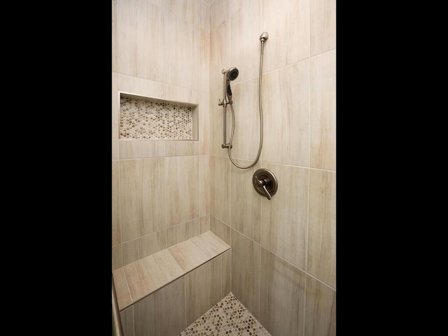 bathroom with a tile shower