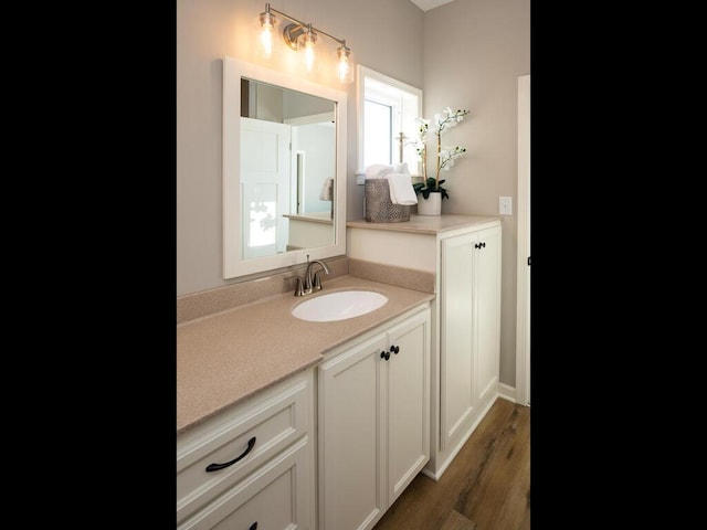 bathroom featuring vanity and hardwood / wood-style flooring