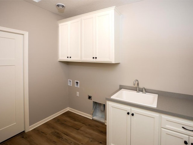 laundry area featuring hookup for a washing machine, electric dryer hookup, sink, dark wood-type flooring, and cabinets