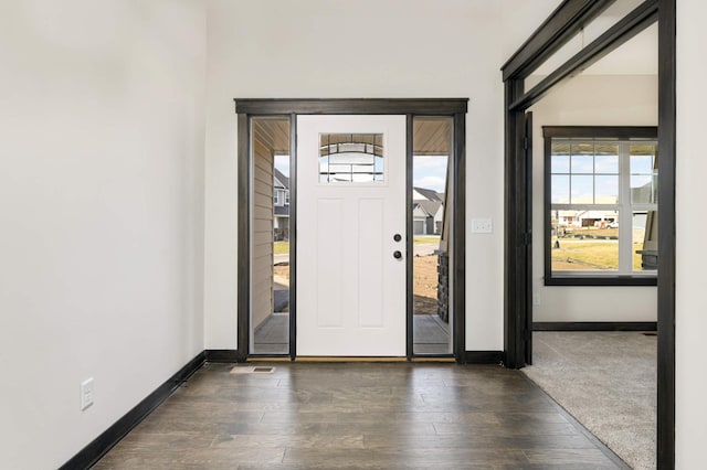 foyer entrance with dark wood-type flooring