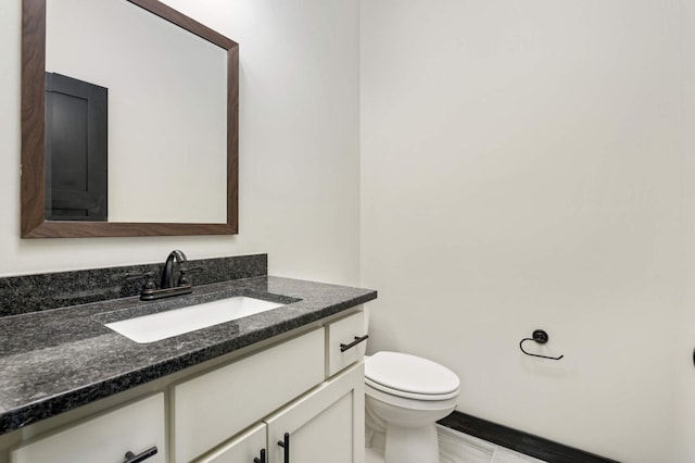 bathroom featuring vanity, toilet, and tile patterned floors