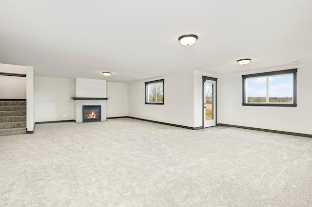 unfurnished living room featuring light carpet