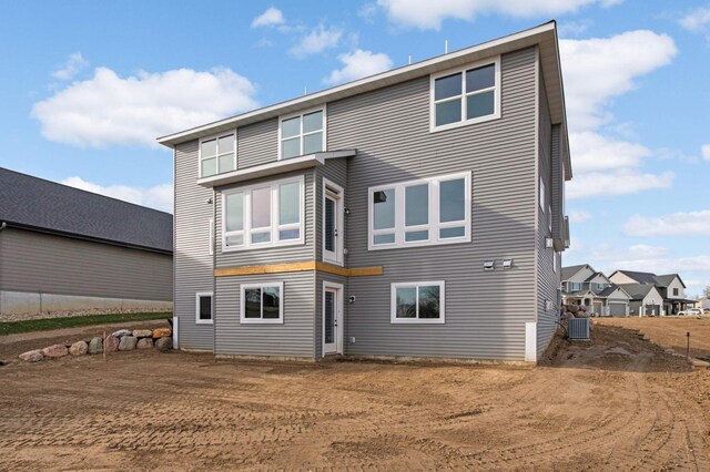 rear view of property with cooling unit