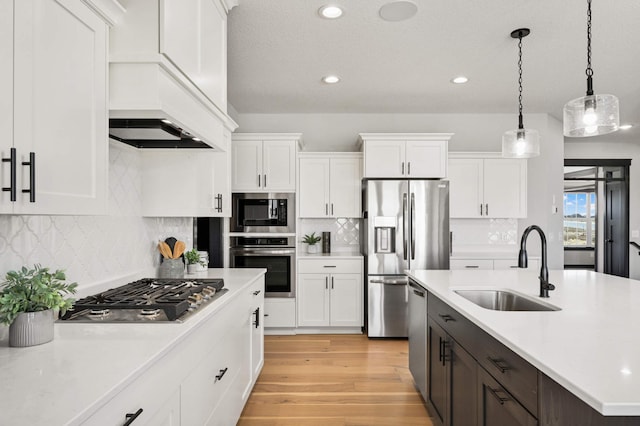 1105 136th St E, Rosemount, MN 55068 - kitchen with appliances with stainless steel finishes, a sink, light countertops, white cabinetry, and recessed lighting