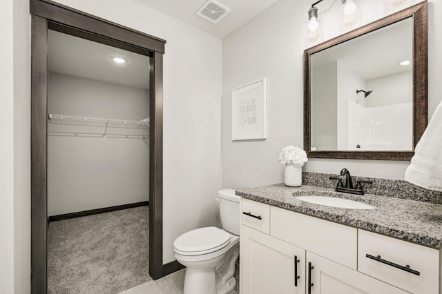 1105 136th St E, Rosemount, MN 55068 - full bathroom featuring vanity, toilet, a walk in closet, a shower, and baseboards