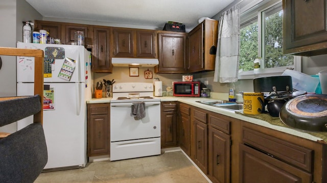 kitchen featuring white appliances and sink