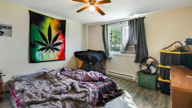 bedroom with ceiling fan, cooling unit, baseboard heating, and wood-type flooring