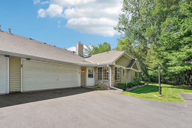 ranch-style home with a garage and a front yard