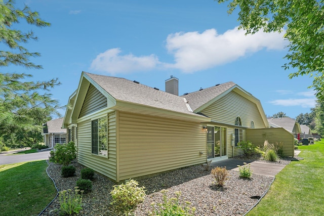 view of home's exterior with a lawn