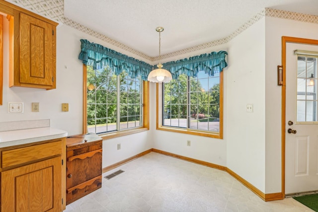 dining space with a textured ceiling