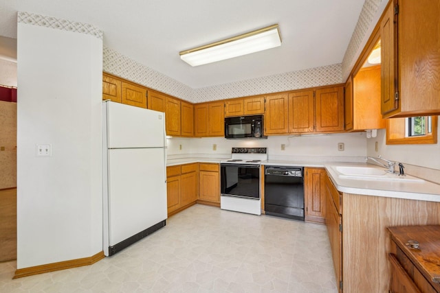 kitchen featuring black appliances, sink, and light tile patterned flooring